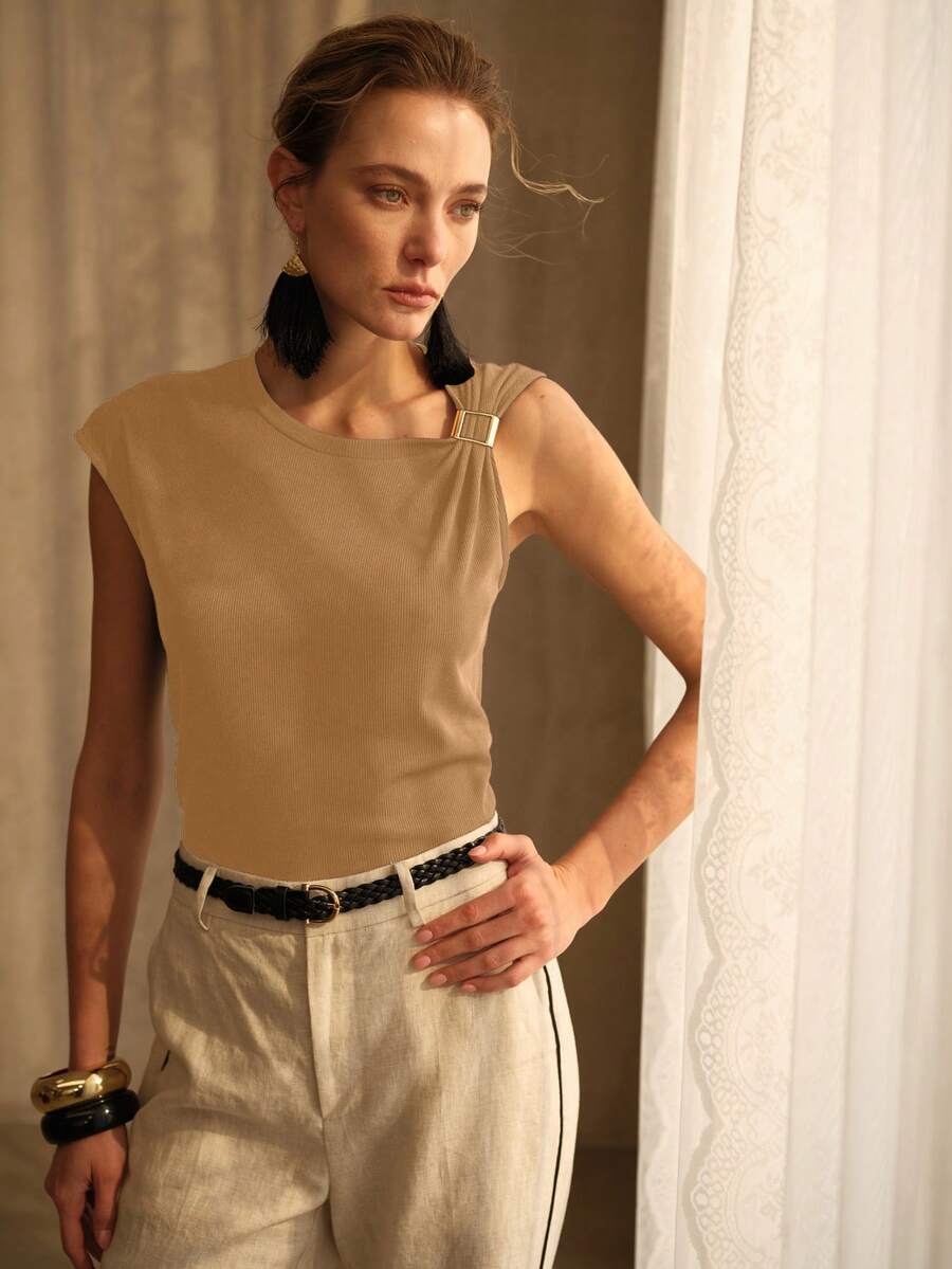 Blusa feminina beige com detalhe de fivela metálica no decote e acabamento elegante para looks casuais e sociais