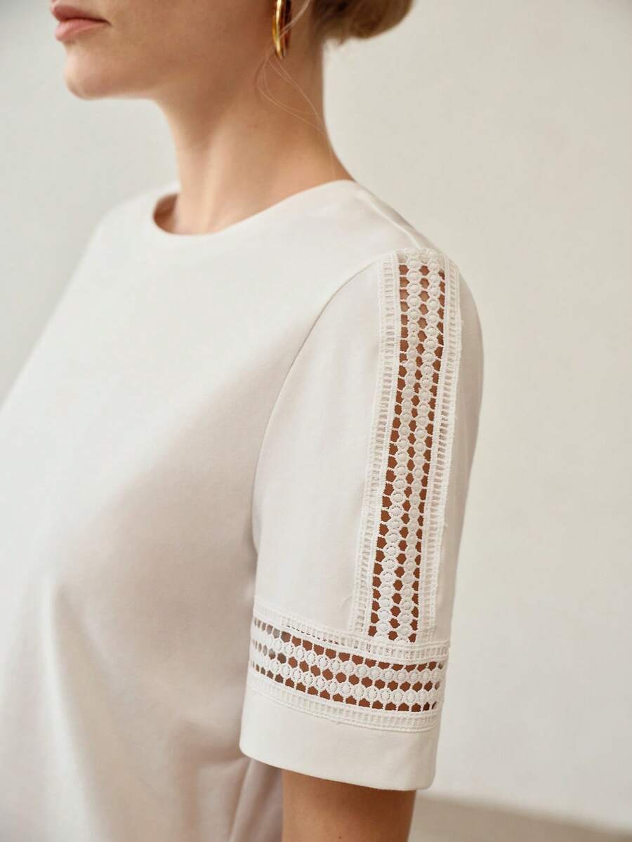 Blusa feminina off whitede manga curta com aplicação vazada delicada nos ombros e acabamento elegante