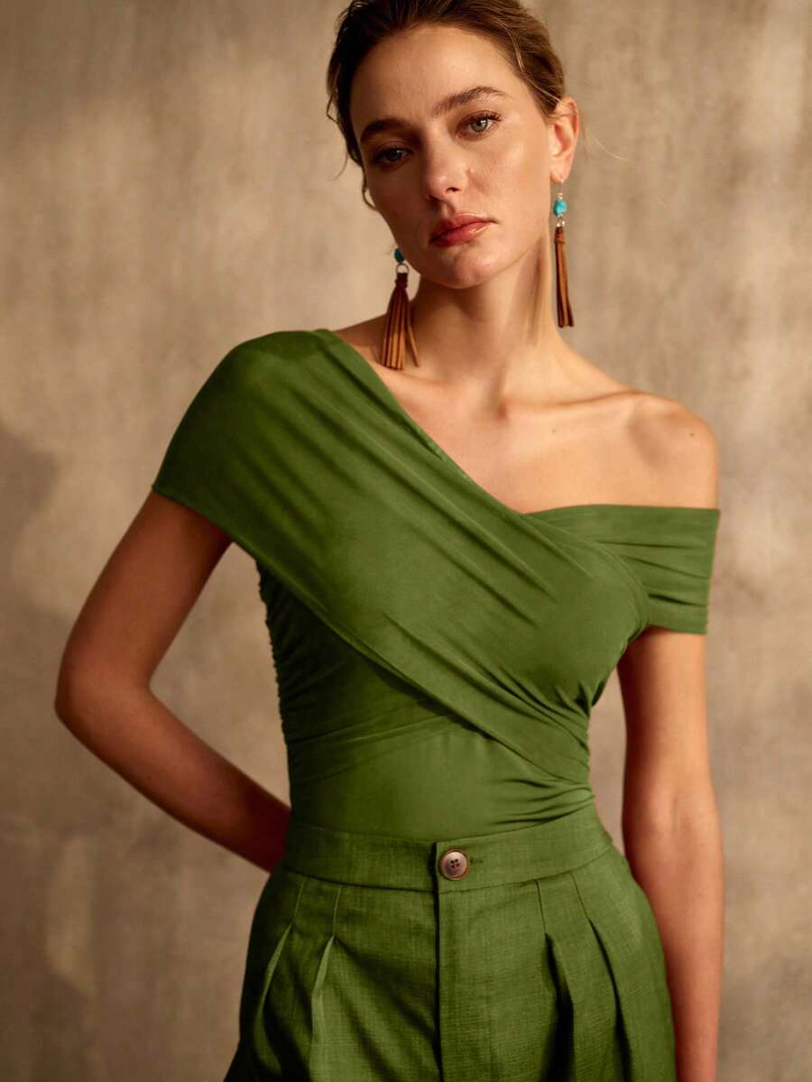 Detalhe frontal da blusa verde transpassada com decote ombro a ombro