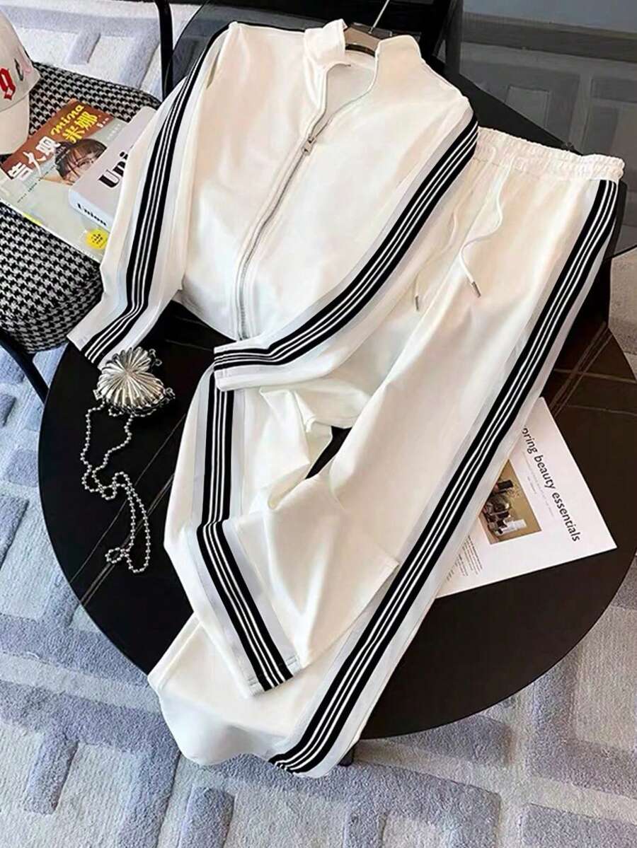conjunto feminino elegante esportivo na cor branco listas pretas com calça ampla