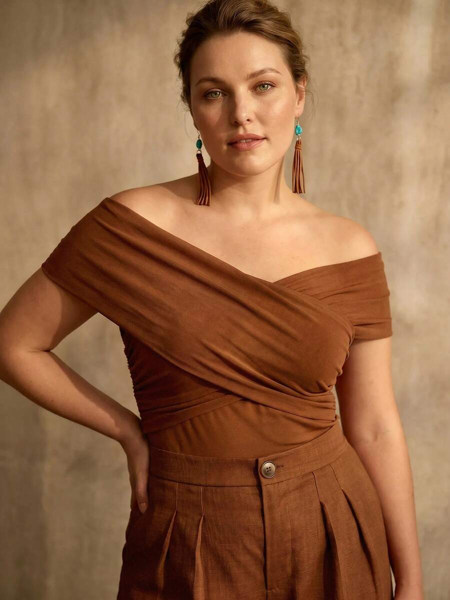 Detalhe do drapeado cruzado da blusa feminina castanho plus size