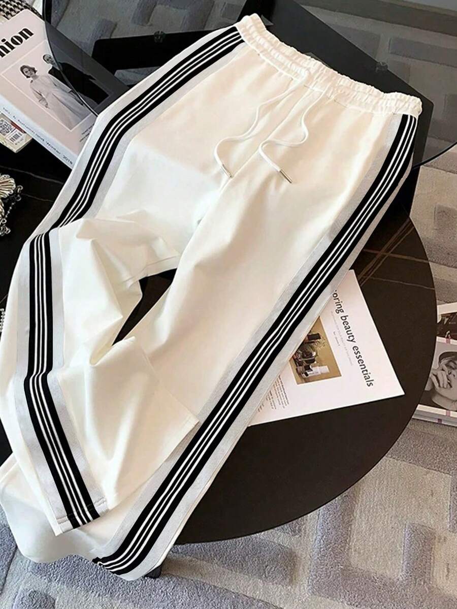 conjunto feminino elegante esportivo na cor branco listas pretas com calça ampla