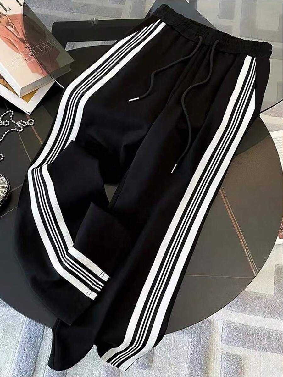 conjunto feminino na cor preta com listas brancas urbano moderno com calça pantalona