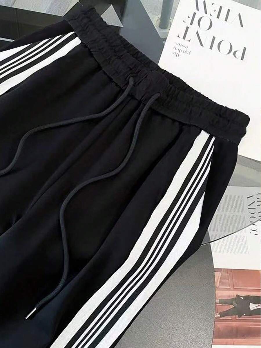 conjunto feminino na cor preta com listas brancas urbano moderno com calça pantalona